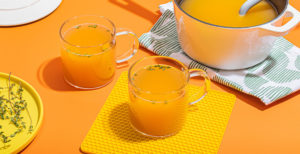 An image of prepared Lemon & Ginger Chicken Bone Broth Toddy made with Pacific Foods® Organic Unsalted Chicken Bone Broth, ginger, garlic, herbs and honey.