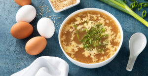 An image of prepared Quick and Easy Egg Drop Soup made with Pacific Foods® Organic Chicken Stock, ginger root, sesame oil and eggs.