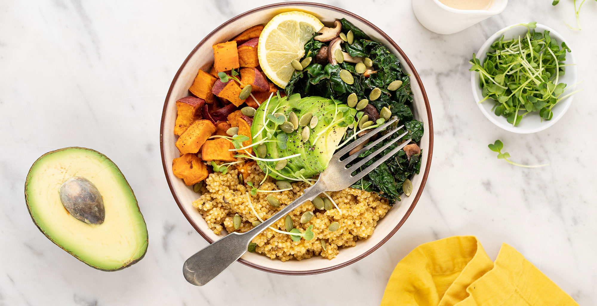 An image of prepared Quinoa Grain Bowl with Mushrooms, Sweet Potato and Kale made with Pacific Foods® Organic Low Sodium Vegetable Broth, Pacific Foods® Organic Cream of Mushroom Condensed Soup, avocado, sweet potato, quinoa, shiitake mushrooms, kale, pumpkin seeds and tahini paste.
