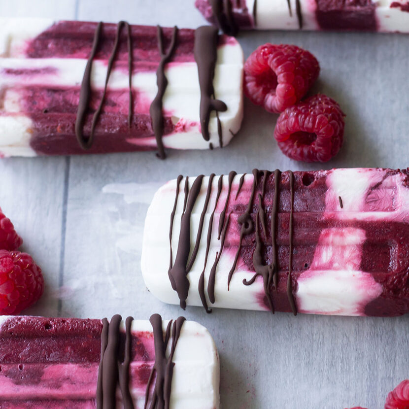 An image of prepared Raspberry Coconut Creamsicles made with raspberries, blackberries, Pacific Foods® Organic Coconut Original Beverage, coconut cream and dark chocolate chips.