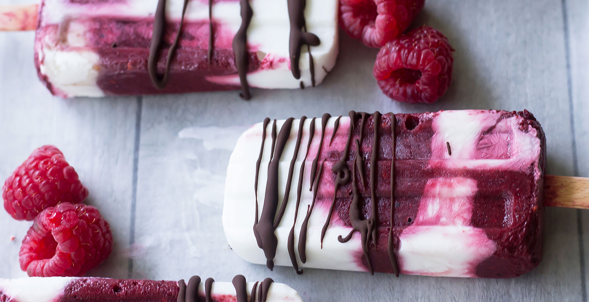 An image of prepared Raspberry Coconut Creamsicles made with raspberries, blackberries, Pacific Foods® Organic Coconut Original Beverage, coconut cream and dark chocolate chips.