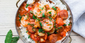 Image of prepared Shrimp Gumbo made with andouille sausage, bell pepper, Pacific Foods® Low Sodium Chicken Broth tomatoes, shrimp and gumbo file powder.