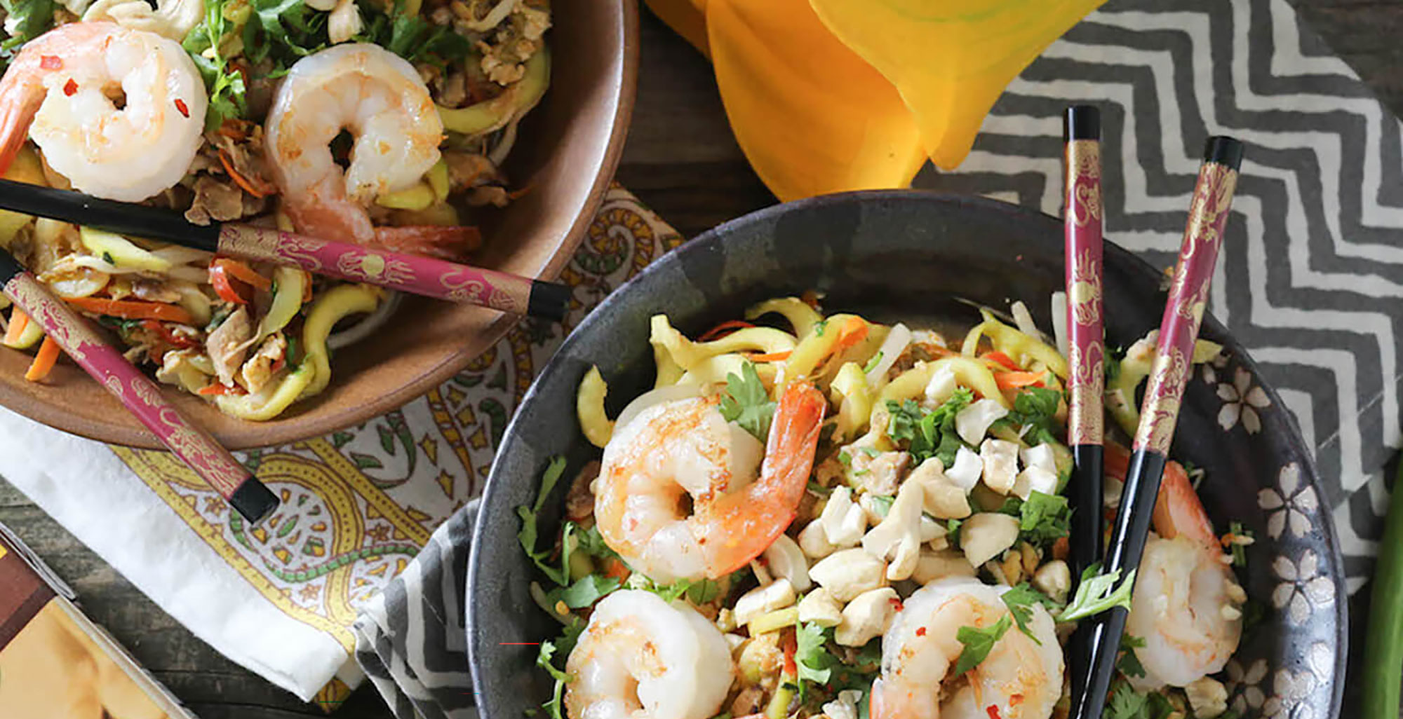 An image of prepared Shrimp & Zucchini Pad Thai made with Pacific Foods® Organic Mushroom Broth, zucchini, shrimp, shittake mushrooms, bell pepper, eggs, bean sprouts, green onion, cashews and cilantro.
