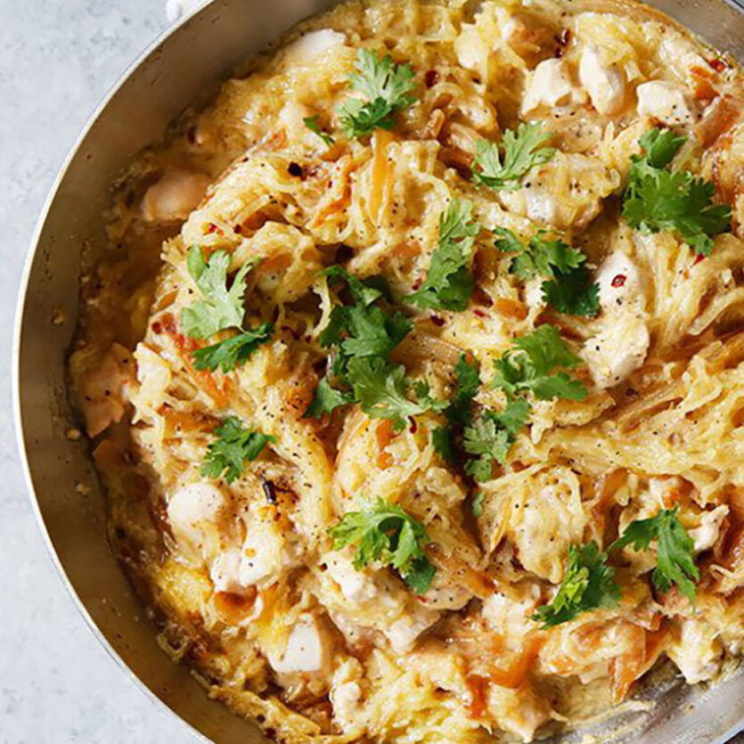 An image of prepared Spaghetti Squash Alfredo with Chicken and Caramelized Onions made with spaghetti squash, onion, chicken, mayonnaise, Pacific Foods® Organic Almond Original Beverage and Parmesan cheese.
