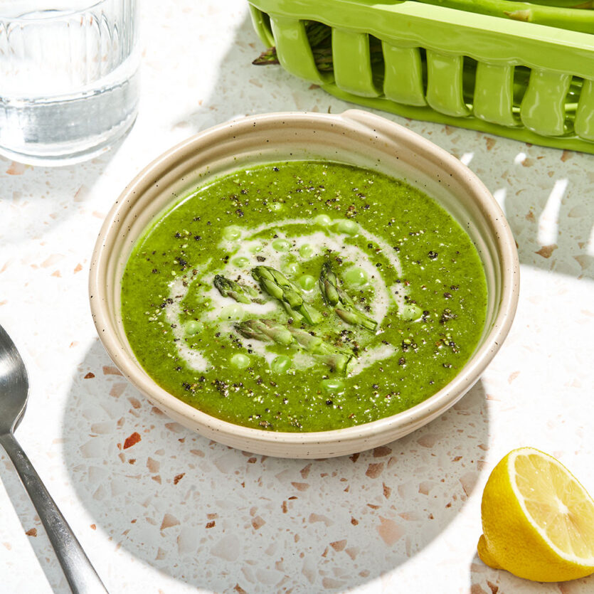 An image of prepared Spring Asparagus and Spinach Soup made with asparagus, yellow onion, ginger, Pacific Foods® Organic Vegetable Broth and peas.