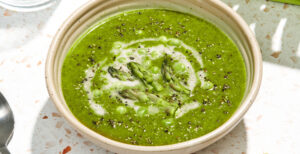 An image of prepared Spring Asparagus and Spinach Soup made with asparagus, yellow onion, ginger, Pacific Foods® Organic Vegetable Broth and peas.