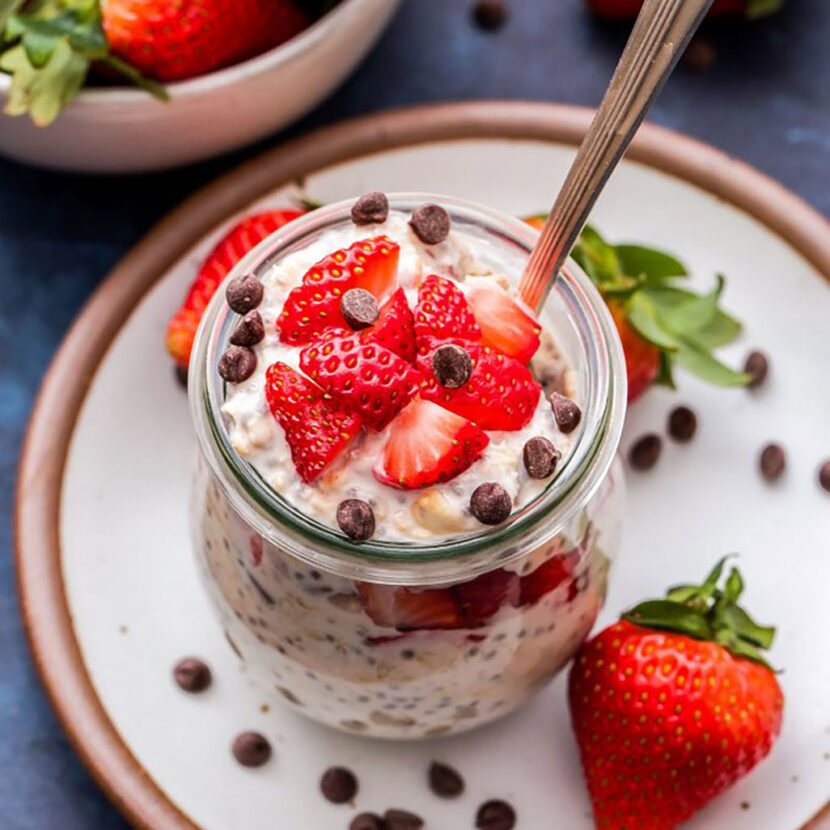 An image of prepared Strawberry Chocolate Chip Overnight Oats made with Pacific Foods® Organic Oat Original Beverage, yogurt, rolled oats, strawberries, chia seeds and mini chocolate chips.