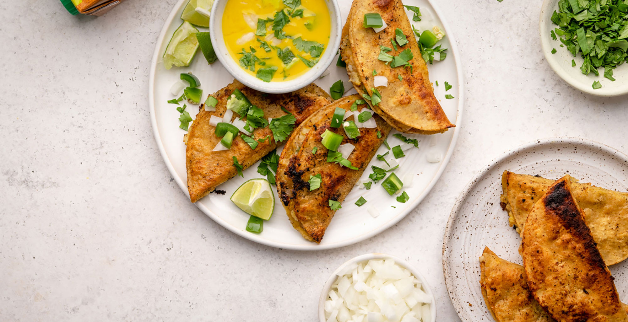 An image of prepared Sweet Potato and Lentil Tacos made with sweet potatoes, onion, lentils, Pacific Foods® Organic Low Sodium Vegetable Broth, avocado, Greek yogurt and corn tortillas.