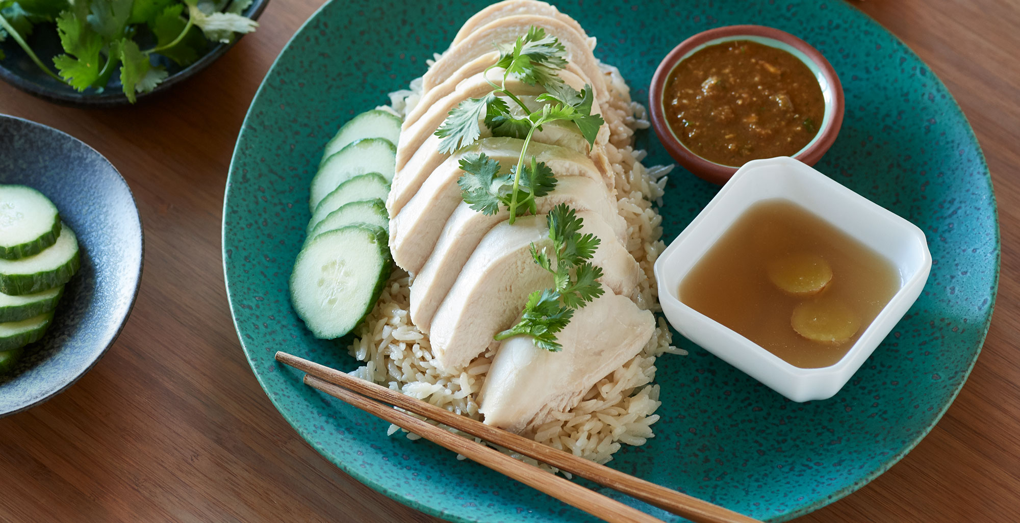An image of prepared Thai Chicken Rice (Khao Man Gai) made with Pacific Foods® Organic Chicken Stock, jasmine rice and chicken.