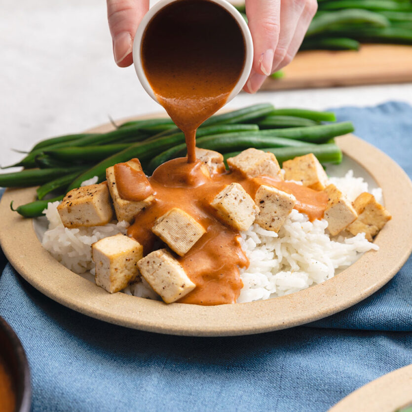 An image of prepared Tikka Masala Sauce made with ginger, garam masala, Pacific Foods® Organic Coconut Unsweetened Original Beverage and Pacific Foods® Organic Creamy Tomato Basil Soup.