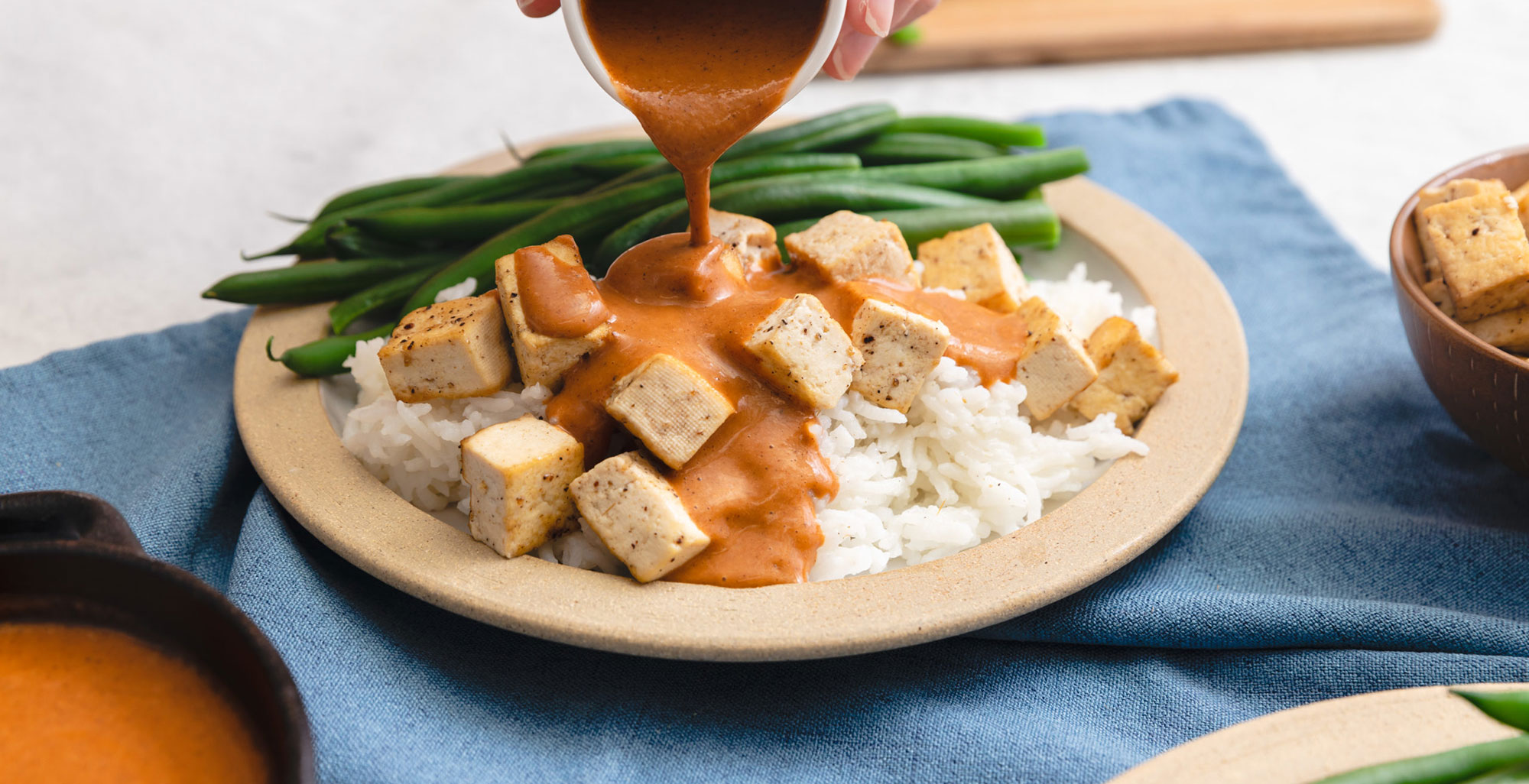 An image of prepared Tikka Masala Sauce made with ginger, garam masala, Pacific Foods® Organic Coconut Unsweetened Original Beverage and Pacific Foods® Organic Creamy Tomato Basil Soup.
