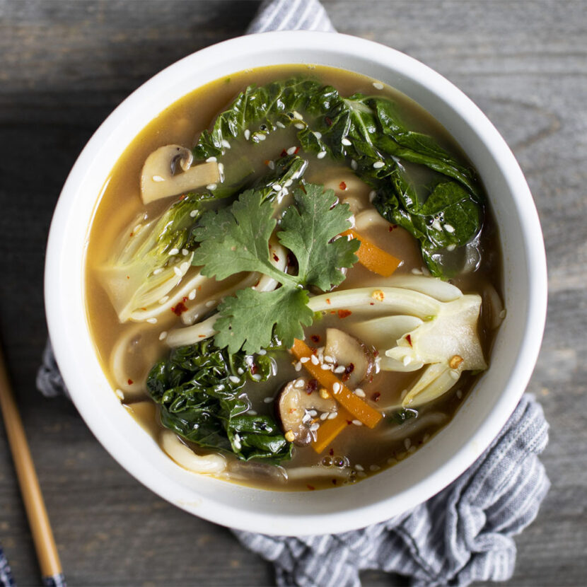 Image of prepared Udon Noodle Soup with Baby Bok Choy made with Pacific Foods® Organic Unsalted Chicken Bone Broth, cremini mushrooms, carrots, baby bok choy and udon noodles.
