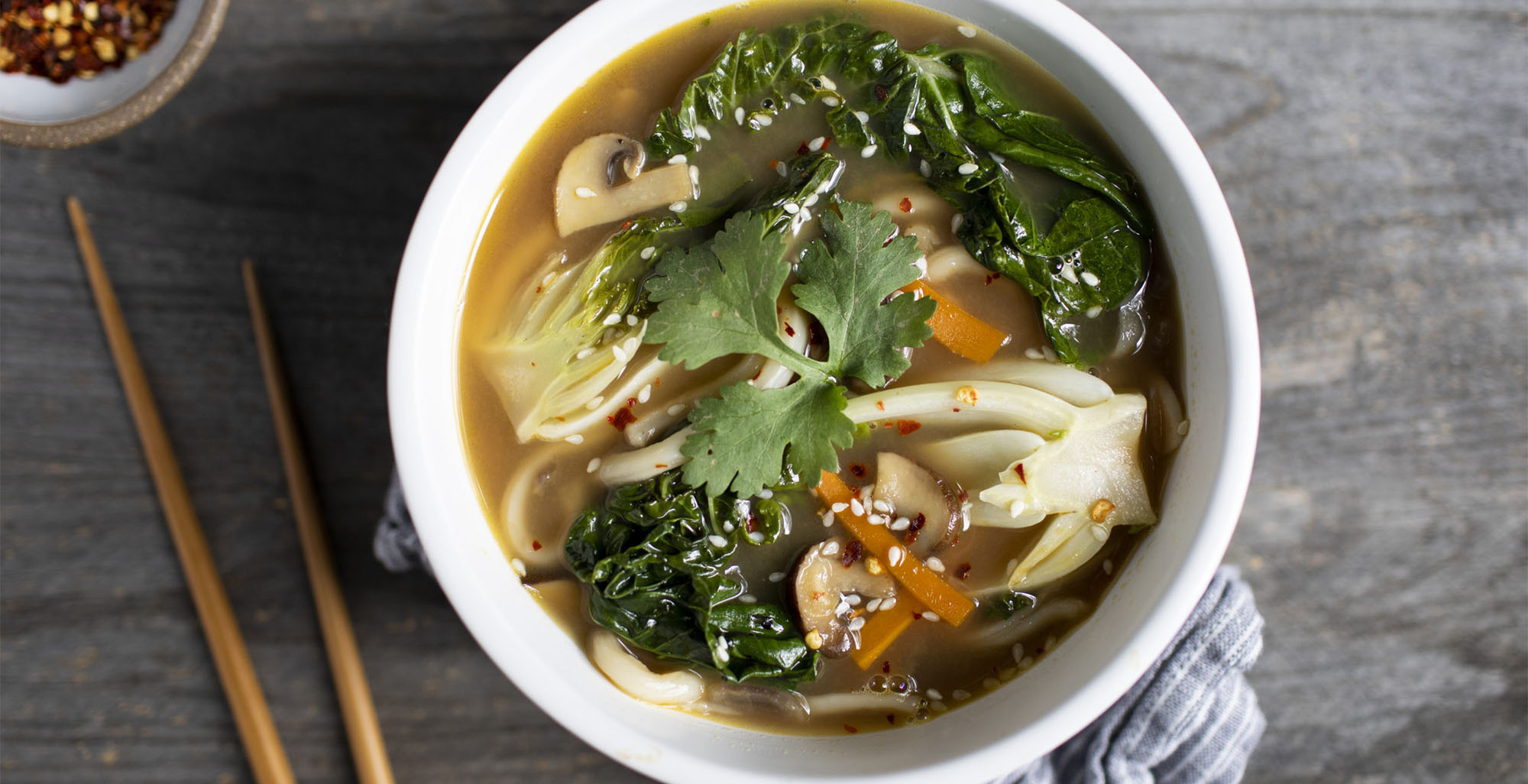 Image of prepared Udon Noodle Soup with Baby Bok Choy made with Pacific Foods® Organic Unsalted Chicken Bone Broth, cremini mushrooms, carrots, baby bok choy and udon noodles.
