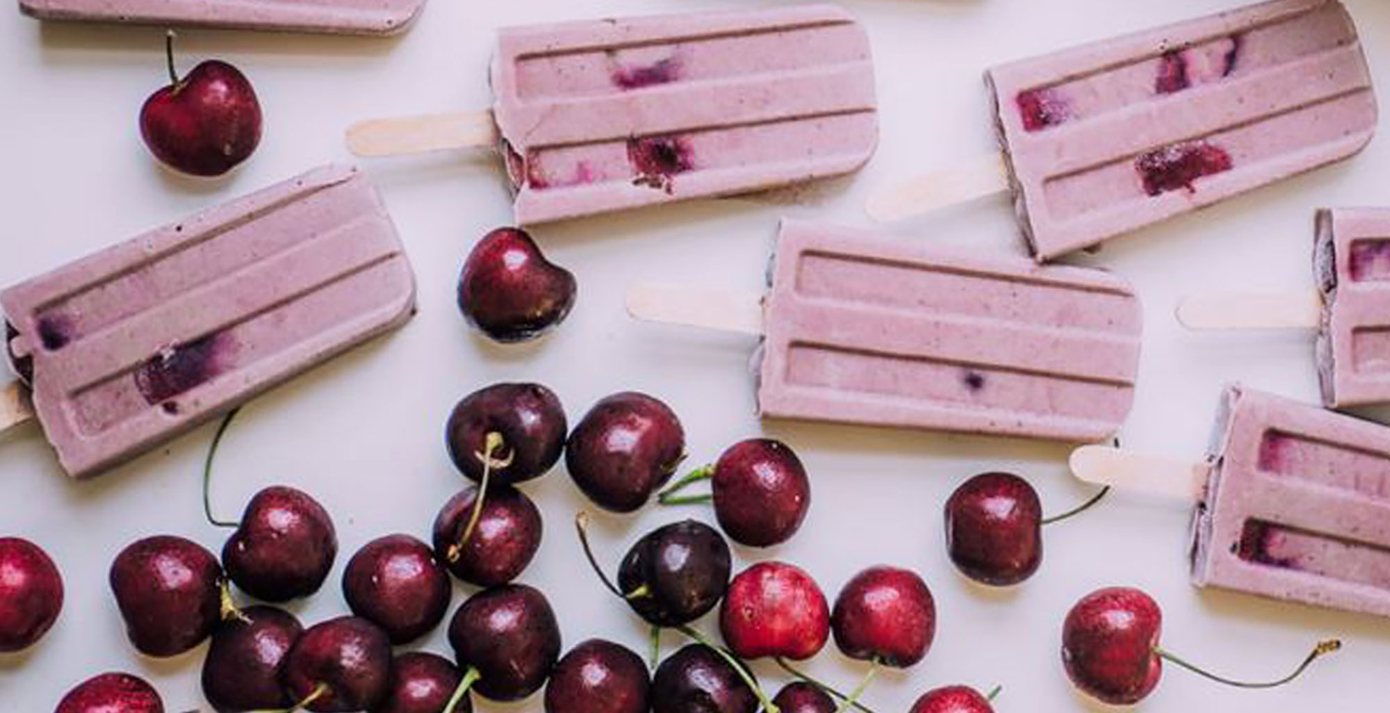 An image of prepared Vegan Cherry Almond Ice Cream Pops made with coconut milk, Pacific Foods® Organic Almond Original Beverage, banana, cashew butter, cherries and dates.
