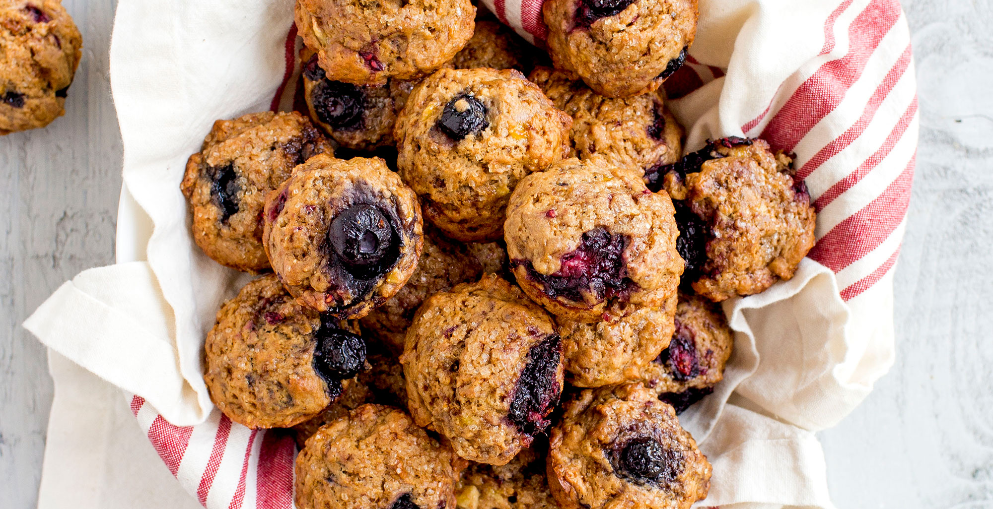 An image of prepared Vegan, Gluten-Free Very Berry Mini Muffins made with banana, Pacific Foods® Organic Oat Original Beverage, mixed berries and gluten free flour.