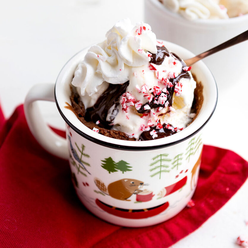 An image of prepared Vegan Peppermint Mocha Mug Cakes for Two made with chocolate chips, coffee, Pacific Foods™ Hemp Original Unsweetened Plant-Based Beverage, peppermint extract and vegan dairy free whipped cream.