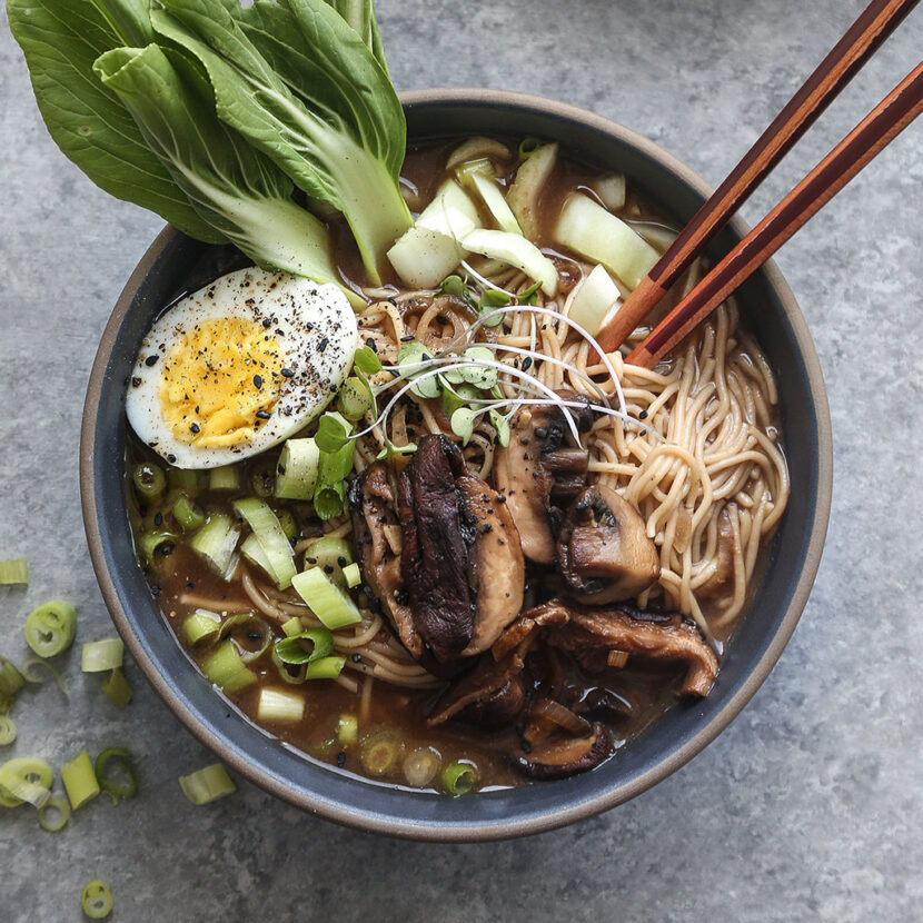 An image of prepared Vegetarian Miso Ramen with Bok Choy made with mushrooms, Pacific Foods® Organic Mushroom Broth, brown rice ramen noodles, red miso paste, sriracha, baby bok choy and hard cooked eggs.