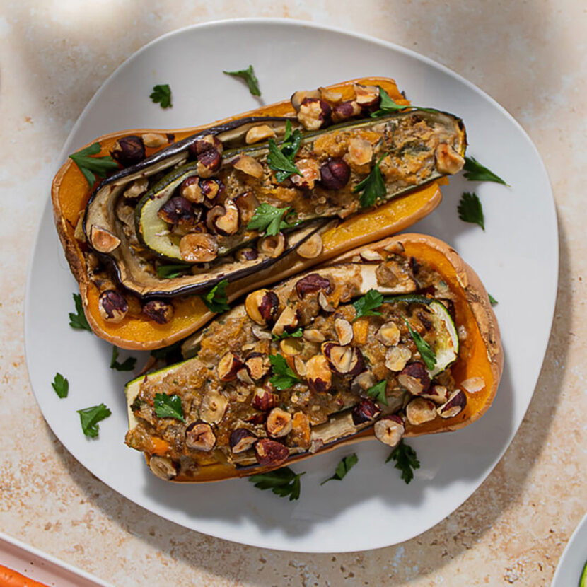 An image of prepared Veggie Stuffed Butternut Squash (aka Butternut Zucchini Plant) made with zucchini, eggplant, butternut squash, parsley, Pacific Foods® Organic Vegetable Broth, thyme and hazelnuts.