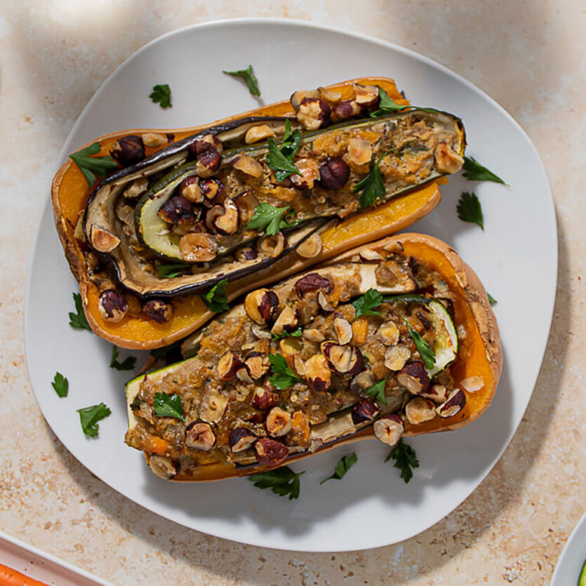An image of prepared Veggie Stuffed Butternut Squash (aka Butternut Zucchini Plant) made with zucchini, eggplant, butternut squash, parsley, Pacific Foods® Organic Vegetable Broth, thyme and hazelnuts.