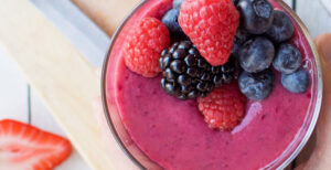 An image of prepared Very Berry Smoothie made with banana, Pacific Foods® Organic Almond Beverage and mixed berries.