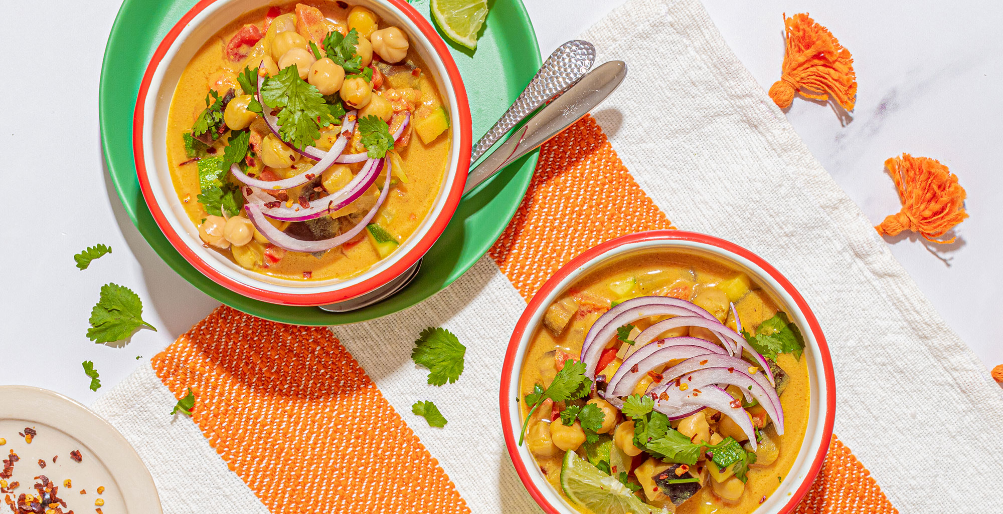 An image of prepared Warming Vegetable and Chickpea Curry made with eggplant, onion, pepper, zucchini, turmeric, Pacific Foods® Organic Vegetable Broth, chickpeas and coconut milk.