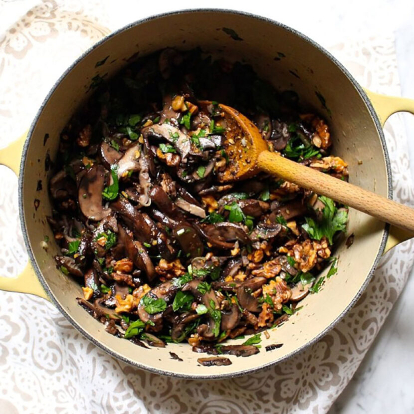 An image of prepared Wild Rice, Mushrooms, and Leek Stuffing made with leeks, celery, wild rice, mushrooms, garlic, parsley, walnut and lemon zest.