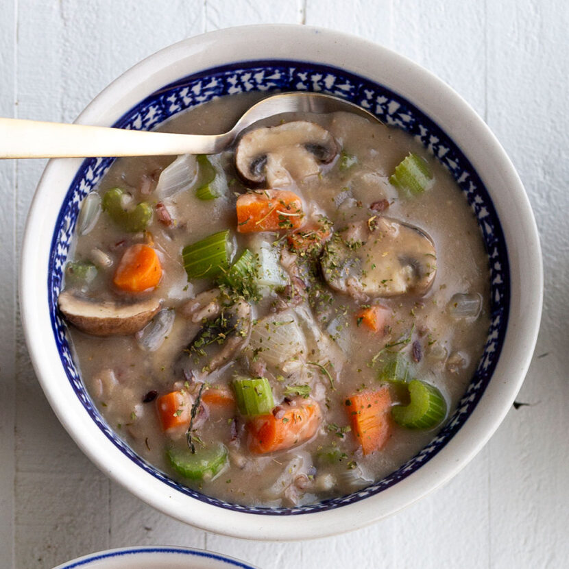 An image of prepared Wild Rice Mushroom Soup made with mushrooms, wild rice, Pacific Foods® Organic Mushroom Broth, Pacific Foods® Organic Cream of Mushroom Soup and parsley.