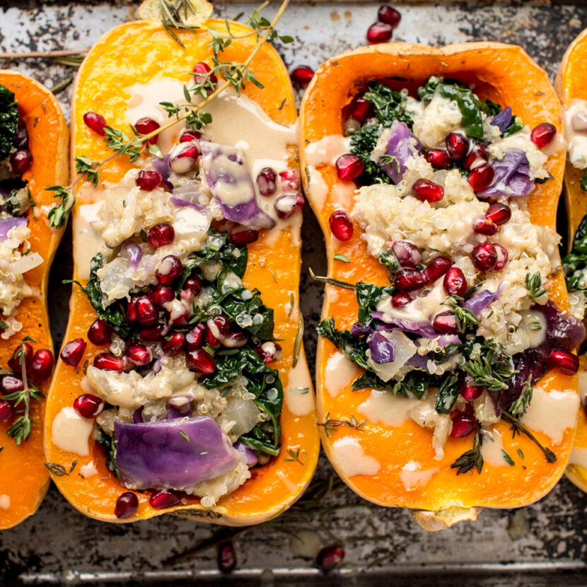 An image of prepared Winter Vegetable and Grain Stuffed Butternut Squash made with butternut squash, quinoa, Pacific Foods® Organic Vegetable Broth, kale, red cabbage, sage, pomegranate seeds and thyme.