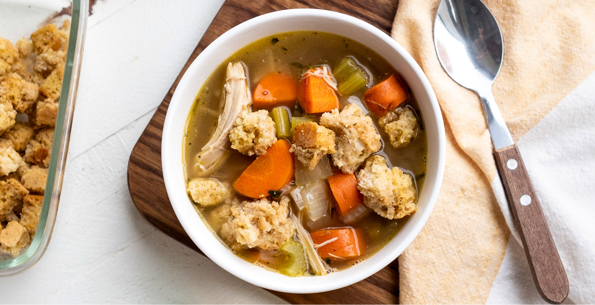 An image of prepared Gratefully Garlic Turkey Soup over Stuffing made with carrots, leftover turkey, leftover stuffing and Pacific Foods® Organic Low Sodium Chicken Broth.