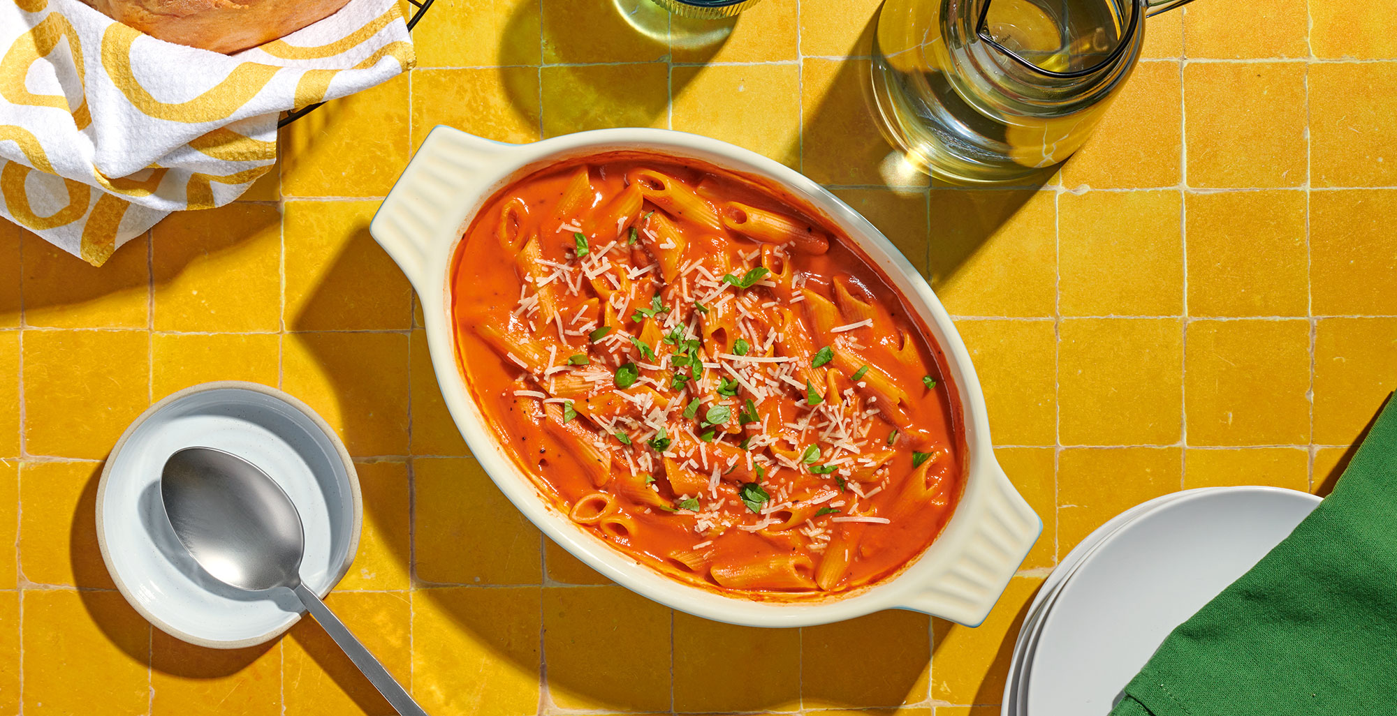 An image of prepared One Pan Roasted Red Pepper Penne Pasta Bake made with Pacific Foods® Organic Roasted Red Pepper & Tomato Soup, Pacific Foods® Organic Vegetable Broth, penne pasta and crushed red pepper.