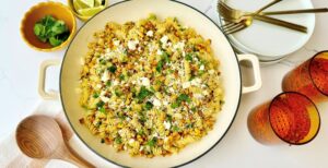 An image of prepared Gluten-Free Street Corn Pasta made with gluten free rotini, corn, chili powder, Pacific Foods® Condensed Cream of Celery Soup, green onions, cilantro, sour cream and cotija cheese or queso fresco.