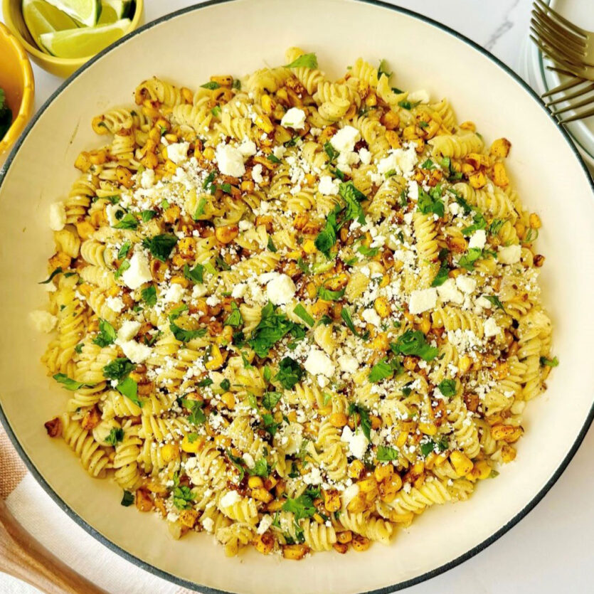 An image of prepared Gluten Free Street Corn Pasta made with gluten free rotini, corn, chili powder, Pacific Foods® Condensed Cream of Celery Soup, green onions, cilantro, sour cream and cotija cheese or queso fresco.