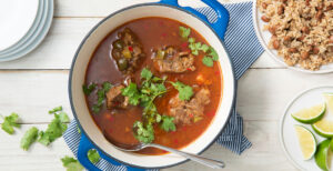 An image of prepared Caribbean Oxtail Stew made with beef oxtails, Pacific Foods® Low Sodium Organic Beef Broth, white rice, Pacific Foods® Low Sodium Organic Beef Broth, Pacific Foods™ Organic Unsweetened Plant-Based Beverage, pinto beans and cilantro.