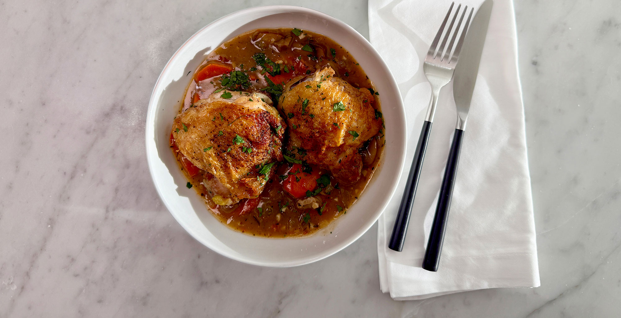 An image of prepared Creamy Chicken & Mushroom Fricassee made with chicken thighs and drumsticks, white wine, Pacific Foods® Organic Free Range Chicken Broth, Pacific Foods® Organic Cream of Mushroom Condensed Soup, carrots, celery and onion.