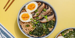 An image of prepared 15-Minute Spicy Red Miso Ramen made with Pacific Foods® Organic Free Range Chicken Broth, gochujang, white miso paste, ramen noodles, portobello mushrooms, spinach and egg.