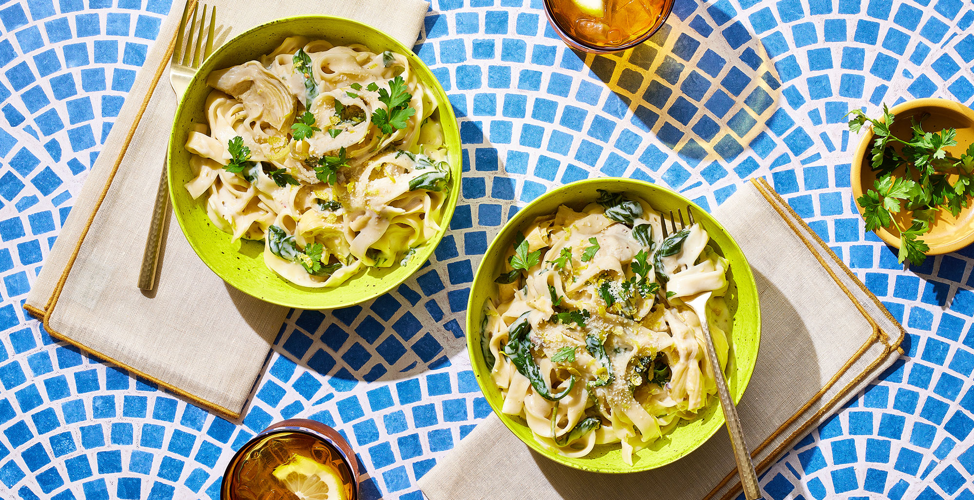 An image of prepared Creamy Spinach and Artichoke Dip Pasta made with pasta, garlic, baby spinach, artichoke hearts, Pacific Foods® Organic Cream of Mushroom Condensed Soup, cream cheese and Parmesan.