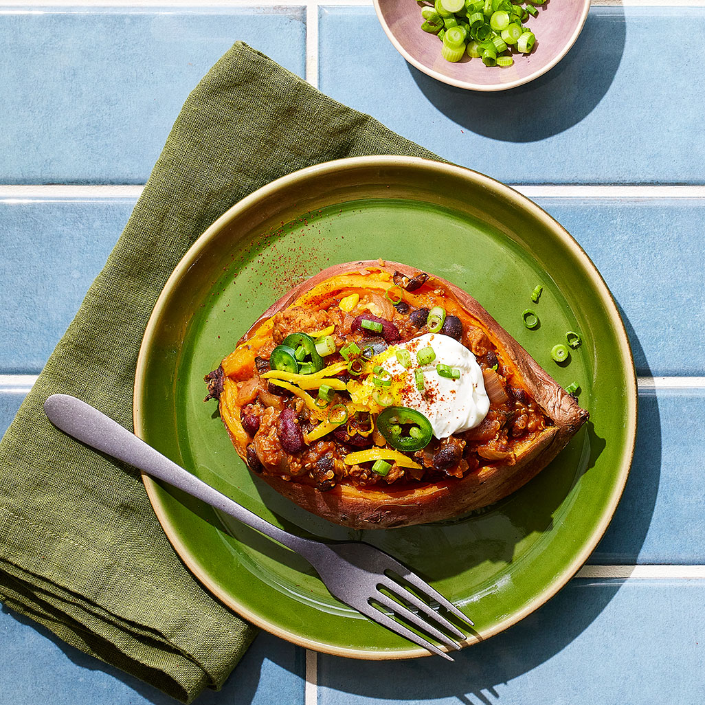 An image of prepared Turkey & Quinoa Chili-Stuffed Sweet Potatoes.