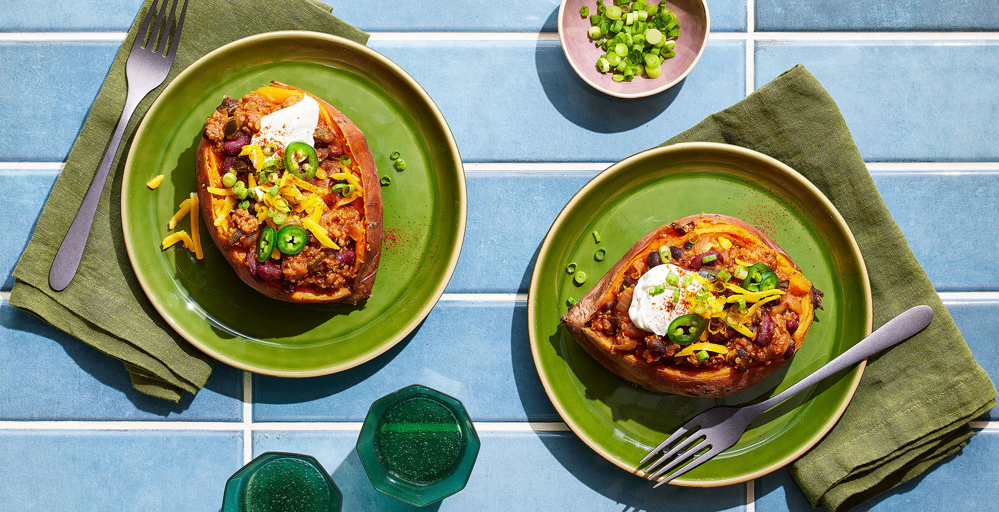 An image of prepared Turkey & Quinoa Chili-Stuffed Sweet Potatoes made with sweet potatoes, ground turkey, onion, poblano, Pacific Foods® Organic Chicken Bone Broth, tomato sauce, quinoa, black beans, and kidney beans.