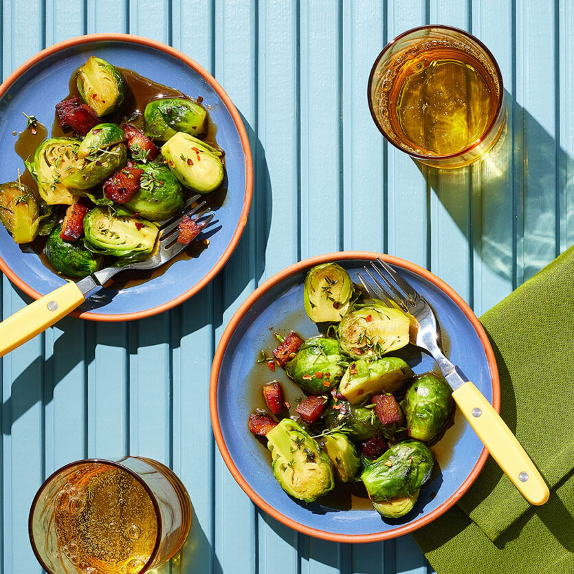 An image of prepared Bourbon Glazed Brussels Sprouts made with pancetta, Brussels sprouts, Pacific Foods® Organic Free Range Chicken Broth, brown sugar, bourbon, thyme and red pepper flakes.