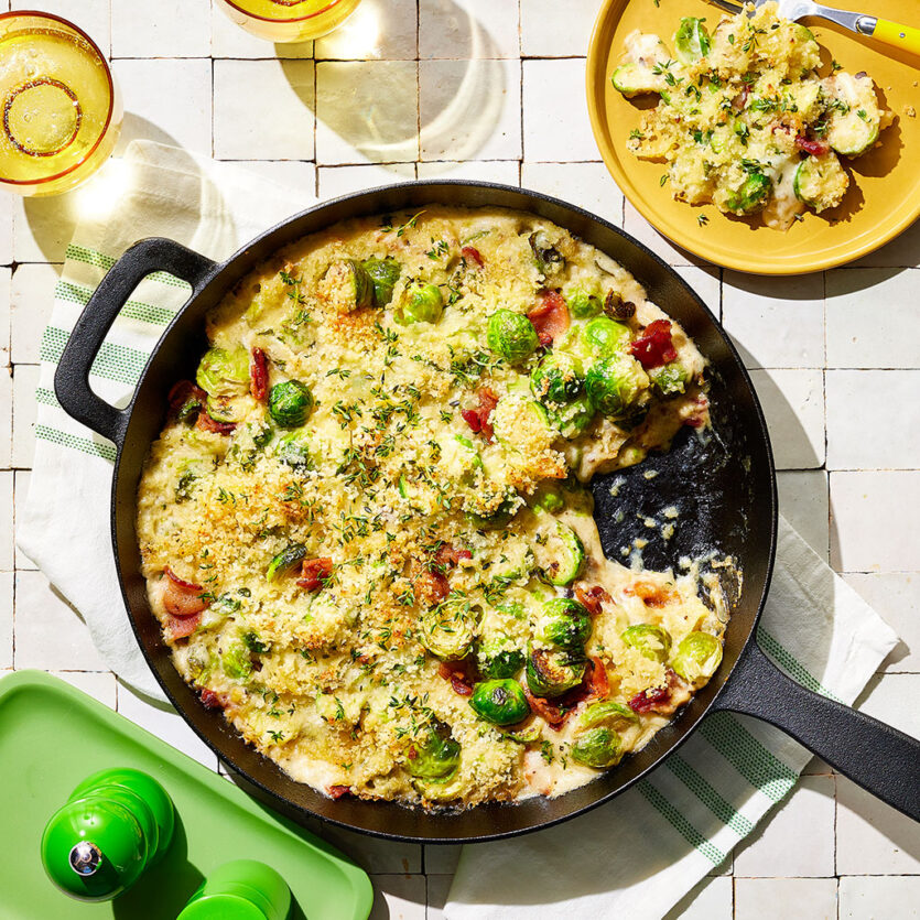 An image of prepared Creamy Brussels Sprouts Gratin made with bacon, Brussels sprouts, thyme, garlic, Pacific Foods® Organic Cream of Mushroom Condensed Soup, cream, Gruyère and Parmesan.