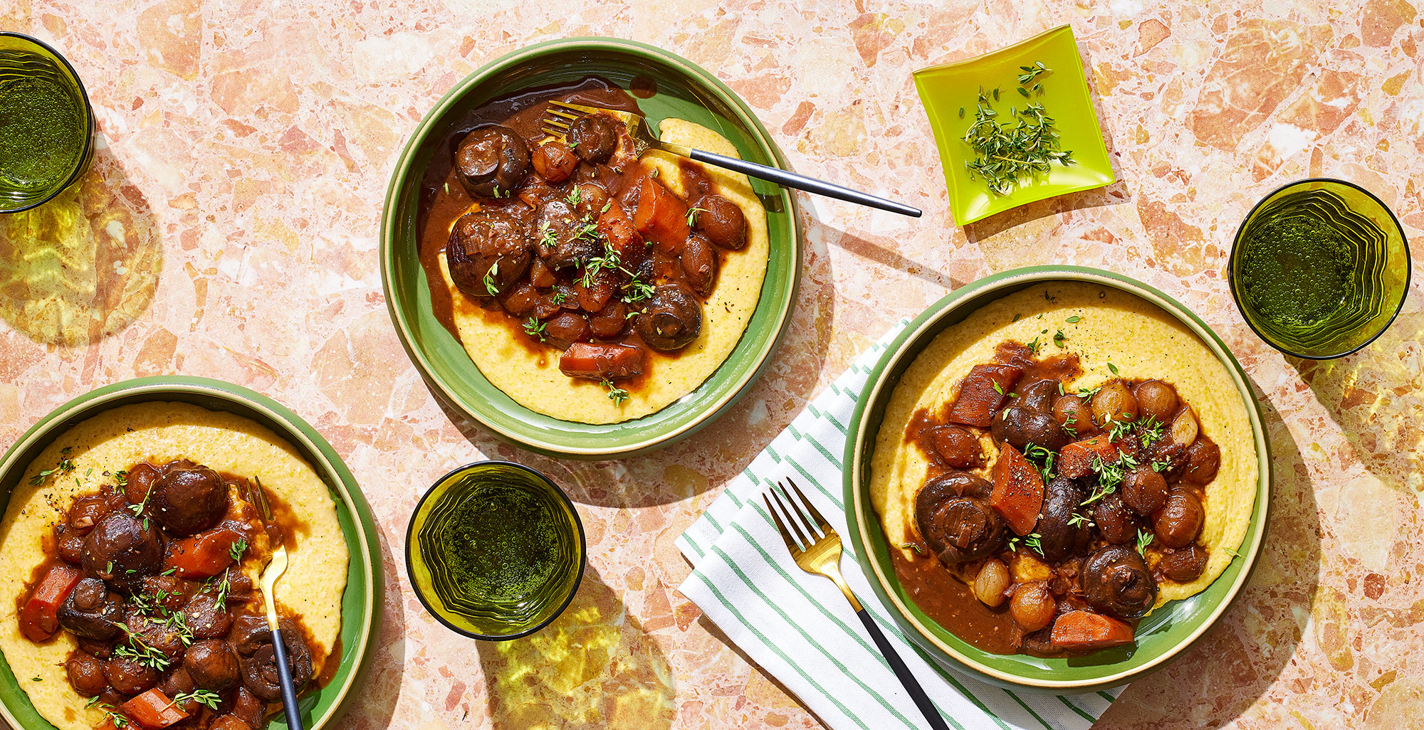 An image of prepared Mushroom Bourguignon & Creamy Parmesan Polenta made with cremini mushrooms, pearl onions, carrots, red wine, Pacific Foods® Organic Low Sodium Vegetable Broth, polenta, cream and Parmesan.