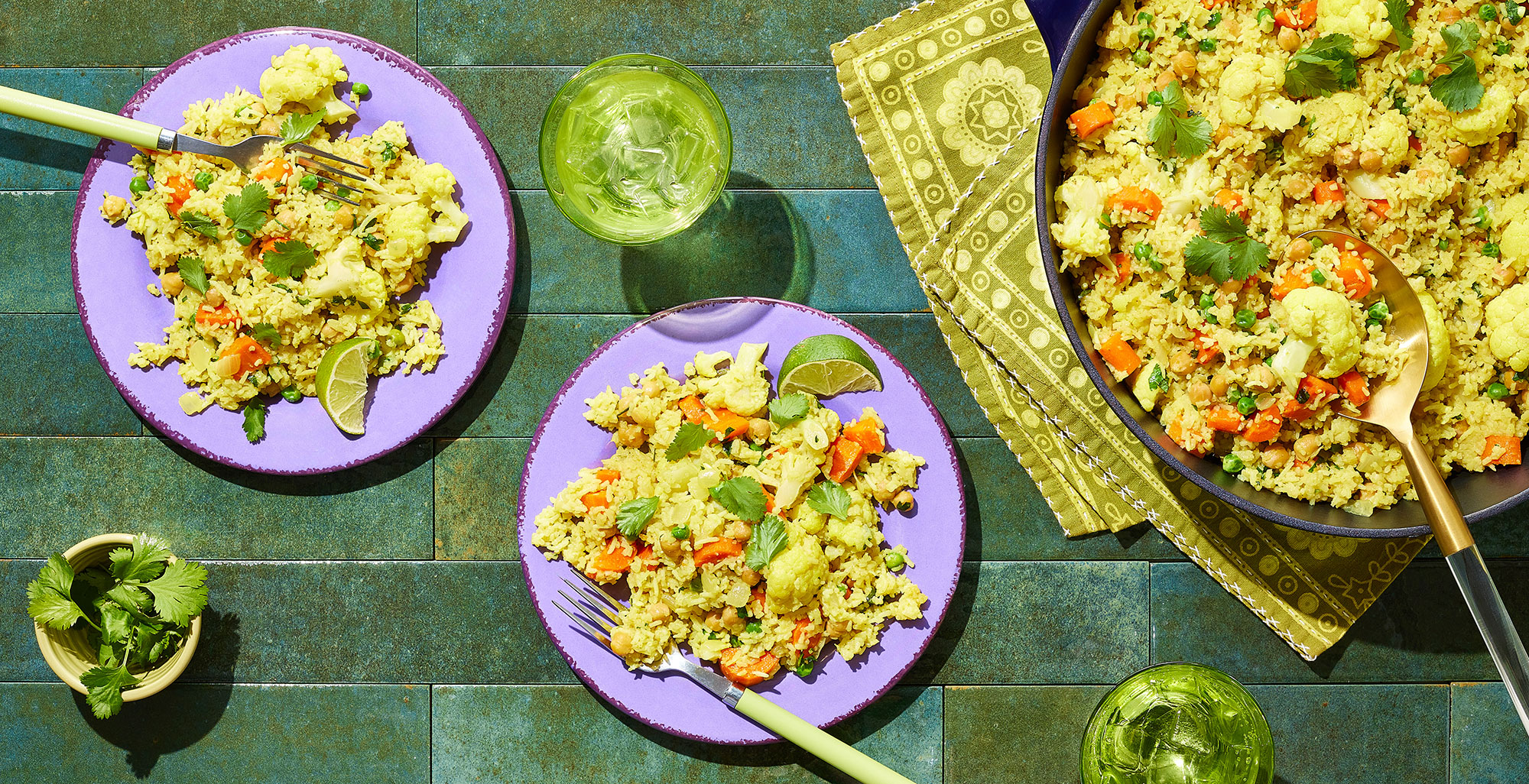 An image of prepared One-Pot Curry Bake made with onion, ginger, curry, coriander, basmati rice, Pacific Foods® Organic Chicken Bone Broth with Sea Salt, Pacific Foods™ Organic Unsweetened Plant-Based Beverage, carrots, garbanzo beans, peas and cilantro.