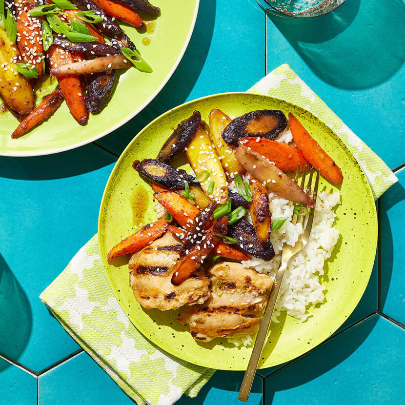 An image of prepared Roasted Carrots with Bone Broth and Maple made with rainbow carrots, Pacific Foods® Organic Unsalted Chicken Bone Broth, butter, maple syrup, white miso paste, Dijon and black pepper.
