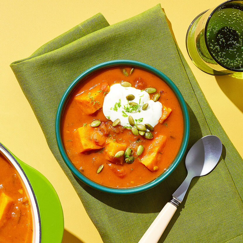 An image of prepared Spicy Sweet Potato Chipotle Soup made with yellow onions, poblano, sweet potato, Pacific Foods® Organic Chicken Bone Broth, fire roasted tomatoes, chipotles in adobo, sour cream and pumpkin seeds.