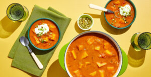 An image of prepared Spicy Sweet Potato Chipotle Soup made with yellow onions, poblano, sweet potato, Pacific Foods® Organic Chicken Bone Broth, fire roasted tomatoes, chipotles in adobo, sour cream and pumpkin seeds.