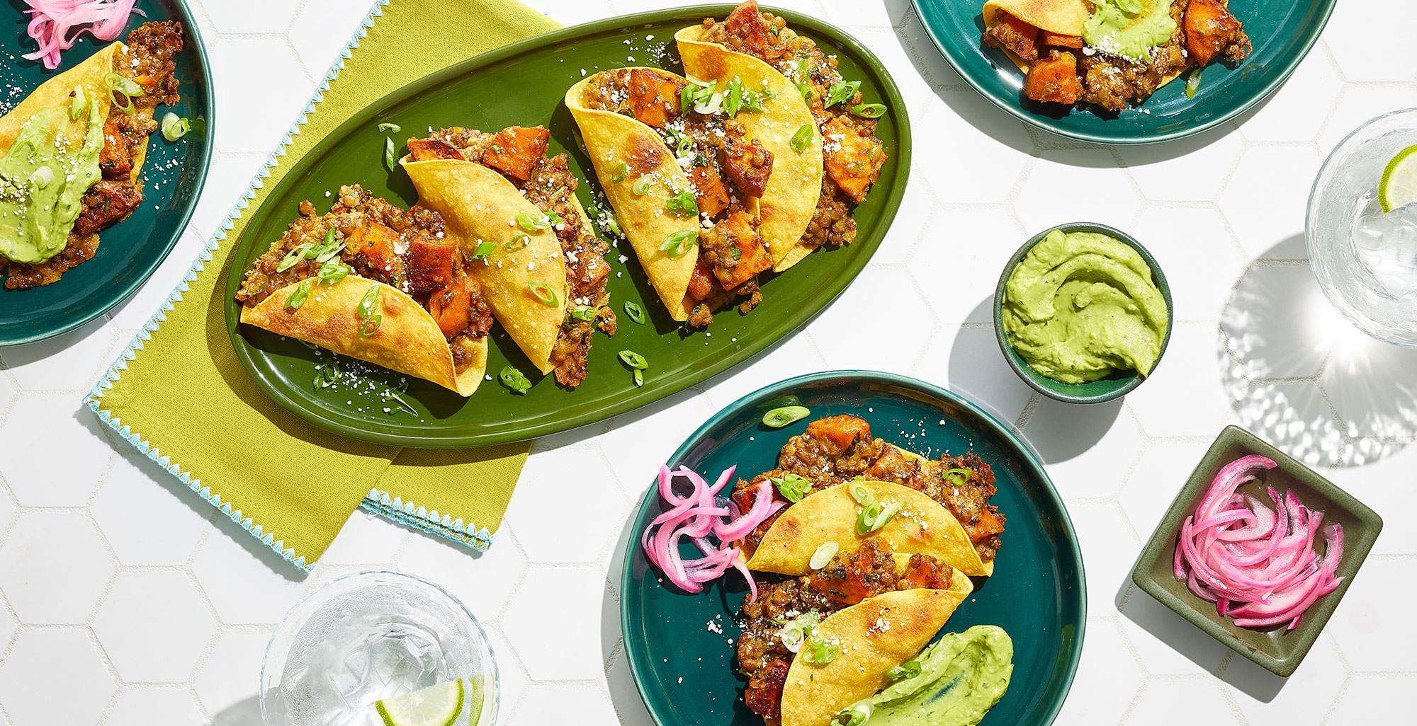 An image of prepared Sweet Potato and Lentil Tacos made with brown lentils, Pacific Foods® Organic Low Sodium Vegetable Broth, sweet potatoes, pepper Jack cheese, sour cream, cilantro, corn tortillas and avocado.