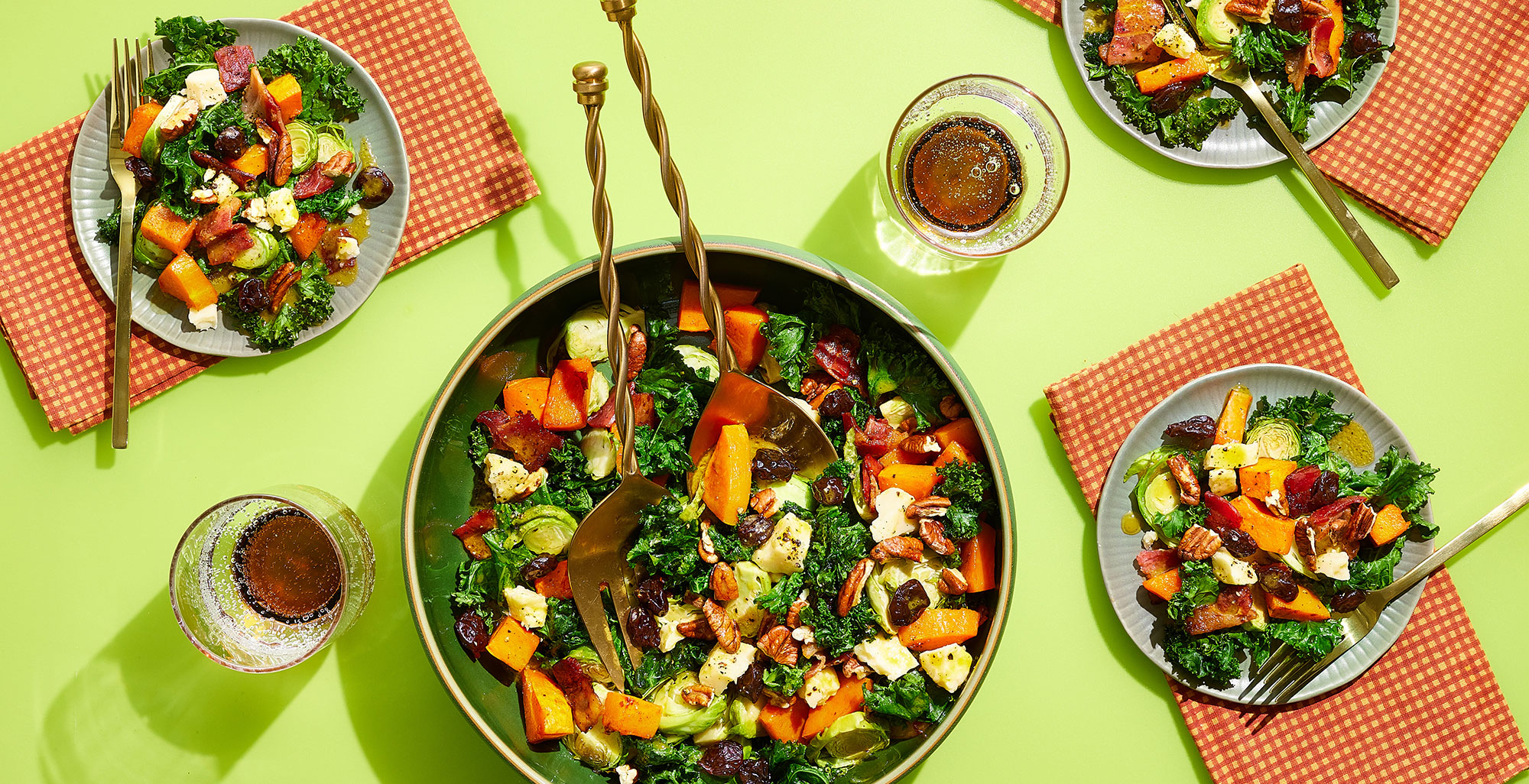An image of prepared Warm Kale Salad with Butternut Dressing & Bacon made with bacon, butternut squash, kale, Brussels sprouts, Pacific Foods® Organic Creamy Butternut Squash Soup, maple syrup, Cheddar cheese, dried cherries and pecans.