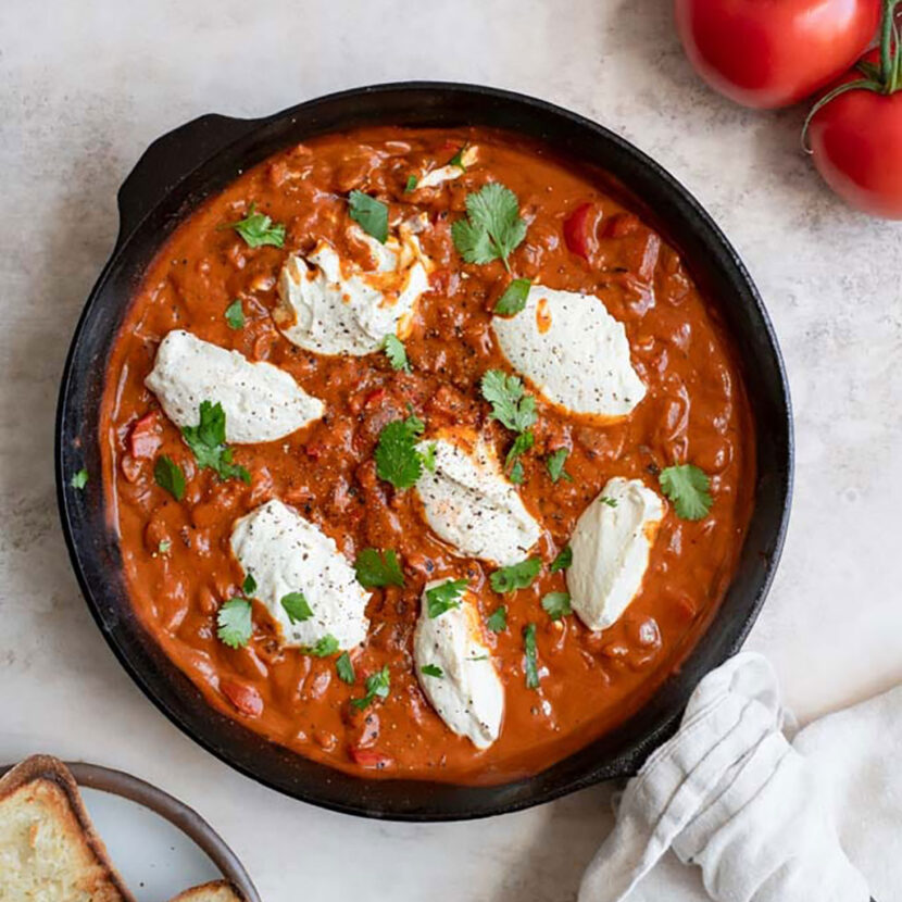 An image of prepared Vegan Shakshuka made with tofu, cashews, onion, pepper, Pacific Foods™ Organic Vegan Creamy Tomato Basil Soup and tomato.