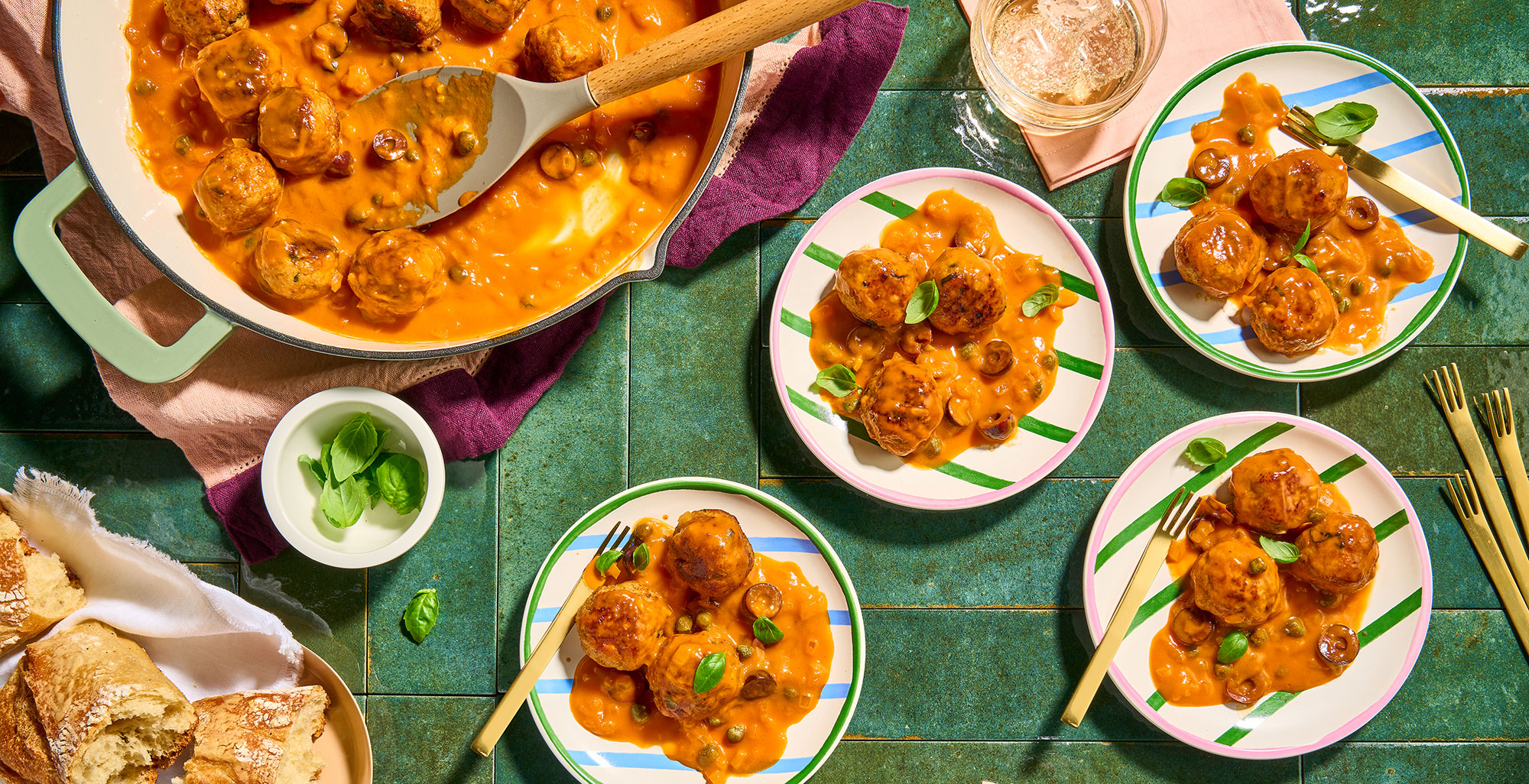 An image of prepared Turkey Meatball Bites with Creamy Puttanesca Sauce made with ground turkey, Pacific Foods® Organic Spicy Garden Tomato Soup, basil, onion, kalamata olives, capers and balsamic vinegar.