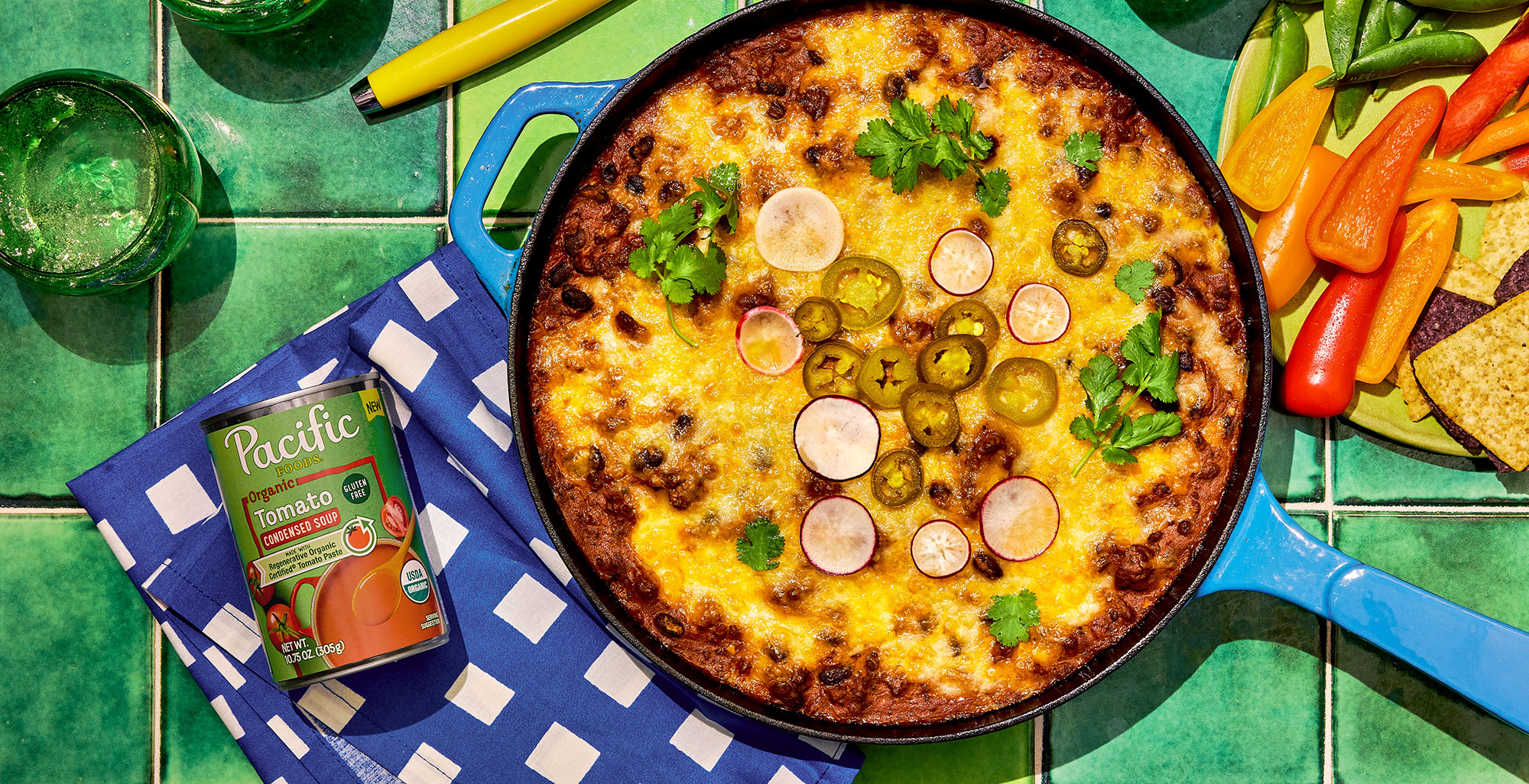 An image of prepared Beef Enchilada Dip made with ground beef, taco seasoning, garlic, Pacific Foods® Organic Condensed Tomato Soup, black beans, cream cheese and Mexican blend cheese.